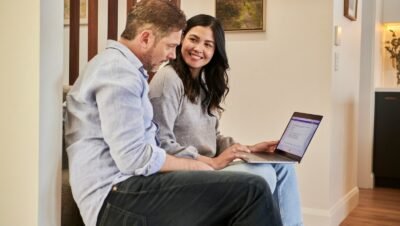 man sitting beside woman looking at a contract on DocuSign