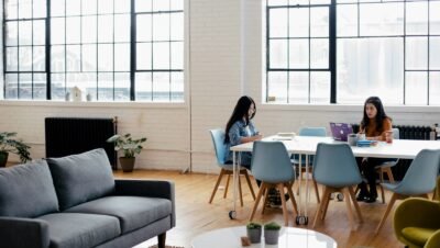 two women sitting in front of white table